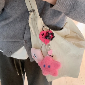 Cute pink plush star and square charms with heart tag on a canvas bag for girls