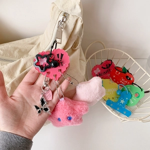 Cute star plush keychain with pink acrylic heart and metal butterfly on a canvas bag