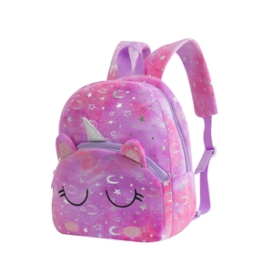 Detail of plush unicorn backpack with glitter horn and stars on pink purple gradient fabric