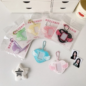 Macro shot of colorful acrylic heart-shaped photocard holders with beaded keychains
