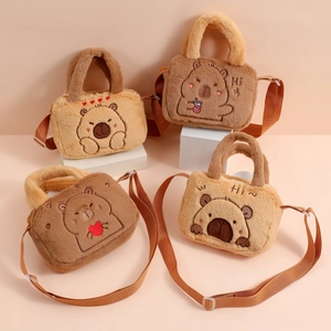 Detail of plush capybara bags with cartoon embroidery and adjustable shoulder straps