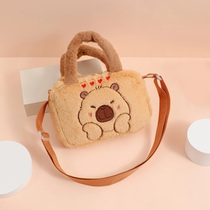 Detail of plush capybara crossbody bag with heart embroidery and soft fur texture