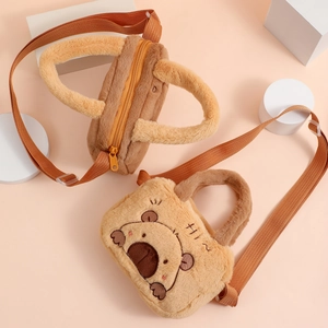 Detail of cute plush capybara crossbody bag with bear embroidery and adjustable strap