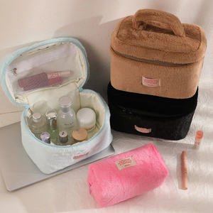 Large plush cosmetic bags in various colors featuring internal mesh pocket and top handle