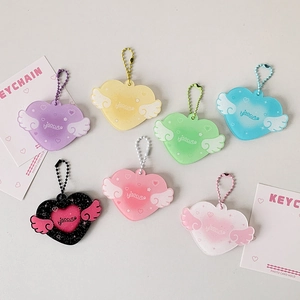 Close-up of heart-winged acrylic photocard holders in vibrant colors with ball chains