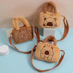 Detail of plush capybara crossbody bags with cute embroidery and adjustable straps