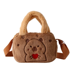 Detail of embroidered capybara holding a heart on a soft brown plush shoulder bag