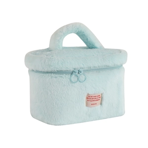 Close-up of fluffy blue plush makeup bag featuring a double zipper and a woven fabric label