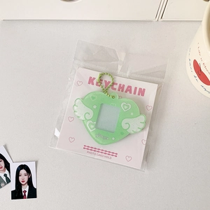 Detail of mint green heart photo card holder with angel wings and glitter finish