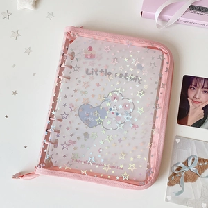 Close-up of pink A5 binder with holographic stars and a secure zipper closure