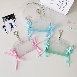 Close-up of glitter acrylic card holders with ribbon bows and heart metal hooks
