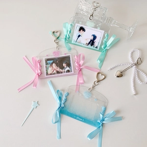 Detailed view of clear photo card holders with satin ribbons and heart metal buckles
