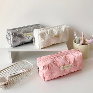 Quilted butterfly pattern pencil cases in pink, white, and silver with zipper closure