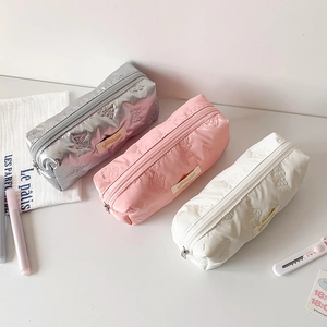 Three-piece set of butterfly embossed stationery pouches in silver, pink, and white
