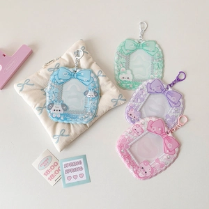 Detail view of colorful bow-themed photocard holders with cute animal motifs and metal hooks