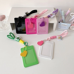 Detailed view of colorful leather card holders with lanyards and heart pendants