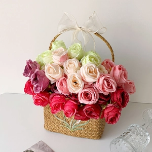 Detail of woven straw flower basket with colorful roses and embroidered floral patterns