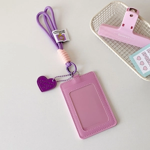 Close-up of lavender PU card holder with matching lanyard and heart-shaped charm detail