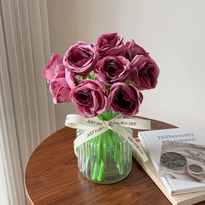 Deep burgundy faux roses in light green ribbed glass vase with Just For You ribbon