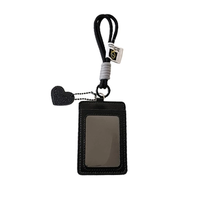 Black leather vertical card holder with woven lanyard and heart charm detail