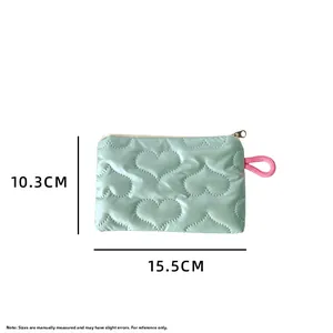 Detail view of mint green quilted pouch with heart pattern and dimensions 15.5cm by 10.3cm