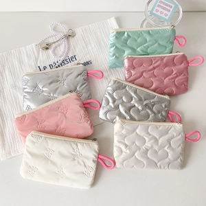 Quilted ribbon bow storage pouches in multiple pastel colors with zipper and side loop