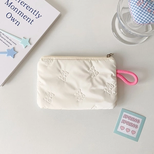 Close-up of white quilted organizer pouch with butterfly texture and pink lanyard