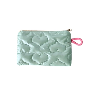 Mint green heart-quilted storage bag with a bright pink strap and secure zipper