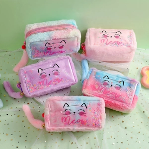 Detailed top view of five plush cat pencil cases with sequins and colorful fuzzy tails