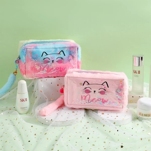 Detail of plush cat makeup bag with sequins and a long faux fur tail zipper puller