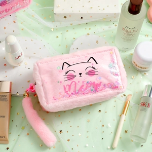 Close-up of pink plush cat makeup bag with glitter sequins and fluffy tail pendant