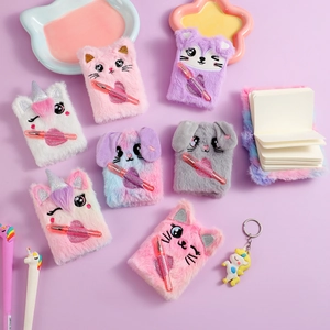 Close-up of plush animal notebook sets with embroidered faces and glitter gel pens