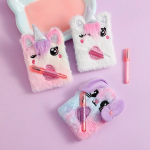 Close-up of plush unicorn and bunny notebooks with matching pens on purple background