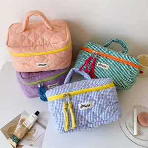 Quilted checkered cosmetic bags in pink purple green and blue with fringe zipper pulls