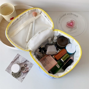 Large blue checkered makeup bag with yellow zipper and internal mesh compartments