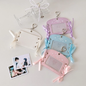 Detail of PU leather card holders with ribbon bows and heart-shaped metal hooks