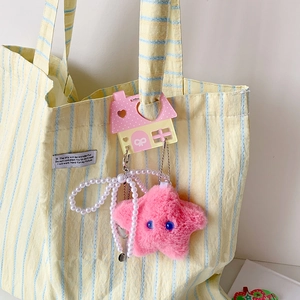 Cute pink plush star keychain with white faux pearls and house-shaped card slot on a bag