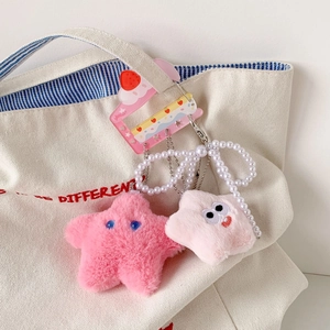 Plush star charms with pearl chain and strawberry card holder on white canvas bag
