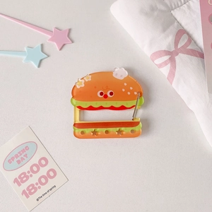 Detail of cute acrylic burger keychain with star cutouts and metal carabiner attachment