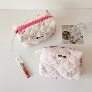 Quilted butterfly print cosmetic bags in cream and pink colors with top handles