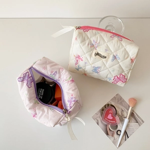 Quilted butterfly cosmetic bags in cream and pink colors with silk ribbon zippers