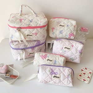 Quilted butterfly cosmetic bag set with purple patterns and ribbon zipper pulls