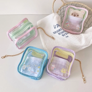 Detail of colorful transparent PVC display bags with cartoon prints and gold chains