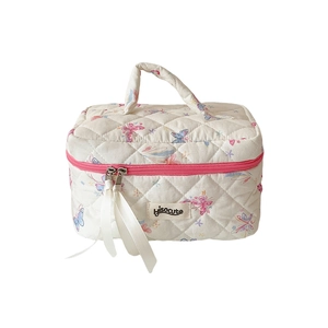 Quilted butterfly cosmetic bag with top handle and ribbon zipper for makeup storage