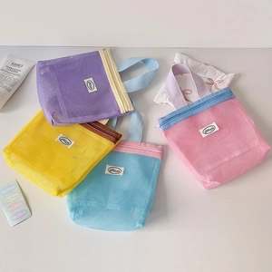 Flat lay of colorful nylon mesh storage bags with zipper closure and webbing handles