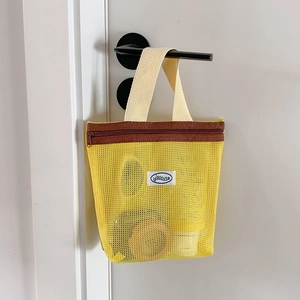 Yellow mesh handbag small cosmetics organizer bag hanging on door handle for travel