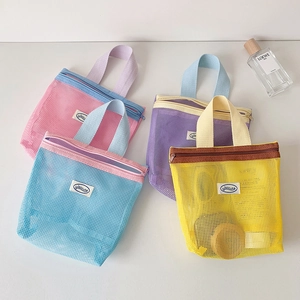 Detailed top view of colorful mesh makeup bags with zippers and woven handles