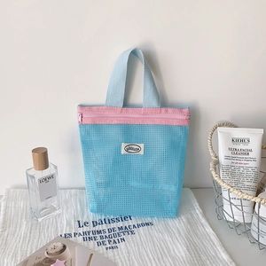 Detail of blue mesh organizer bag with pink zipper for toiletries and skincare