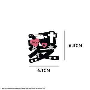 Detail view of the Sweet Punk brooch featuring a black heart character and silver stars