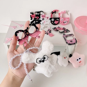 Detail of plush keychain with pearl chain, pink carabiner and cute character accessories